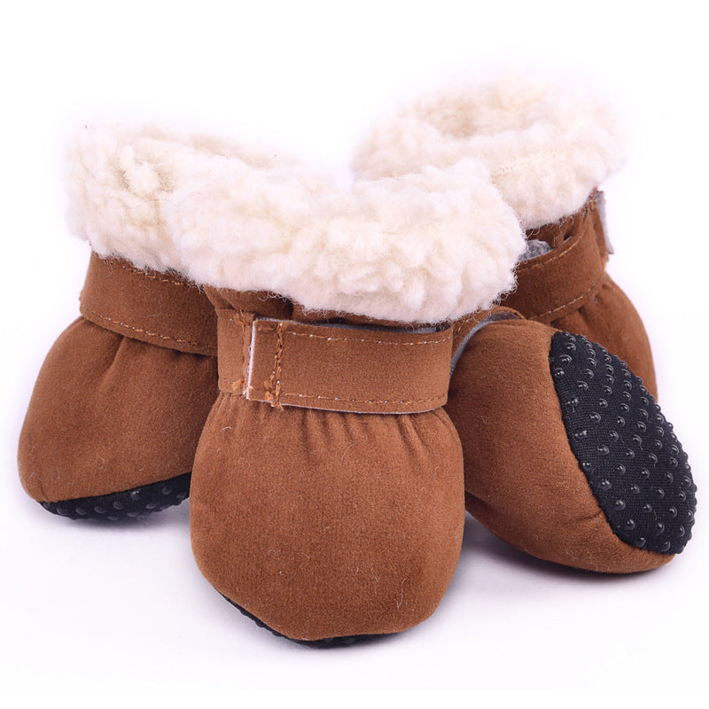 Brown baby booties with soft white fleece lining and non-slip black soles