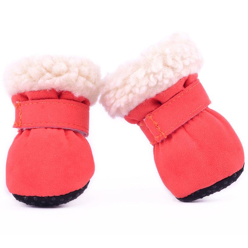 Pair of red winter dog boots with fleece lining and adjustable straps