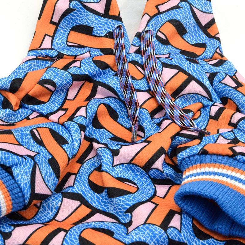 Colorful hoodie with bold orange and blue graffiti-style print and striped blue cuffs